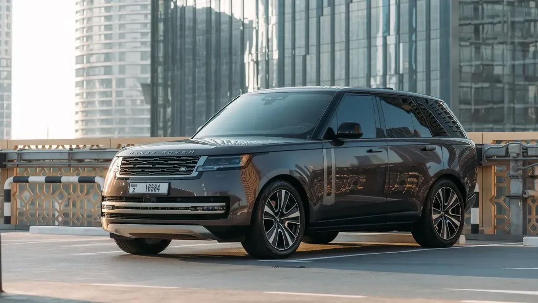 Bronze Range Rover Vogue parked on a Dubai rooftop with the skyline behind it